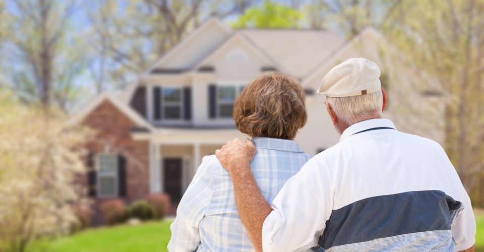 Elderly couple looking at a house