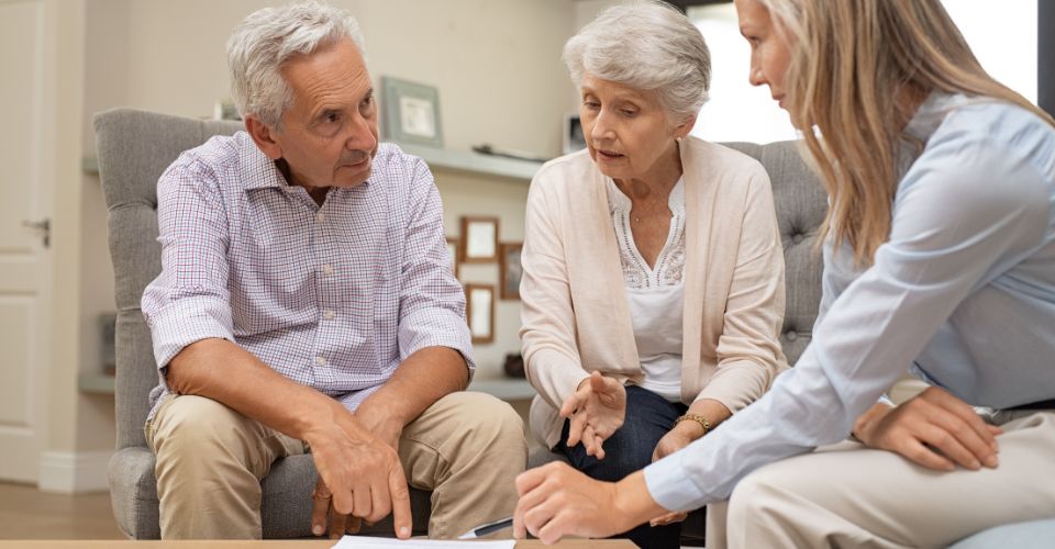 Elderly couple speaking with a lawyer